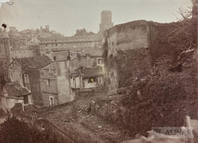 View of buildings in the Campidoglio area that were demolished during refurbishment of the Piazza Venezia area on the occasion of construction of the Vittoriano in Rome. In the background, Torre delle Milizie
