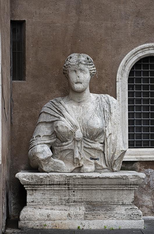 Colossal bust of Isis, called Madama Lucrezia, which originally stood in a temple dedicated to the Egyptian goddess in the Campus Martius, later placed outside the entryway on Piazza San Marco
